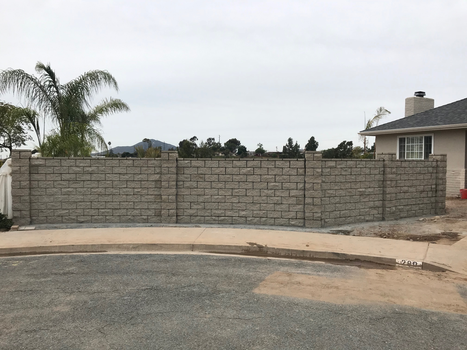 Finished split-face CMU block site wall with pilasters built by Wiley Construction